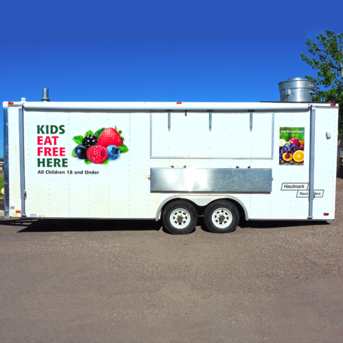Trailer With Kids Eat Free Here And A sticker with assorted fruit attached