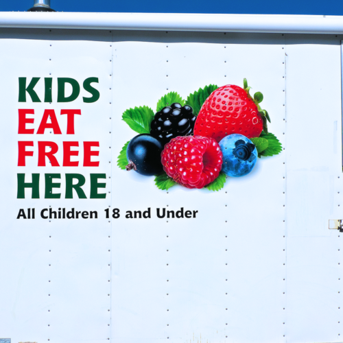 Close up Of Trailer With Kids Eat Free Here And A sticker with assorted fruit attached